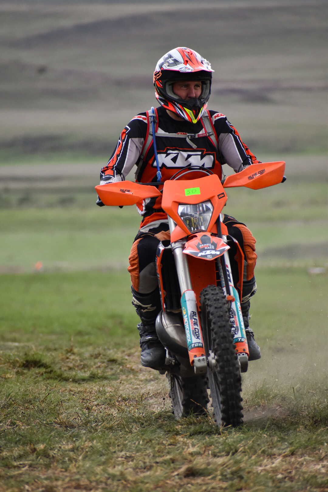 A rider on the enduro course with the Eastern Cape hills behind